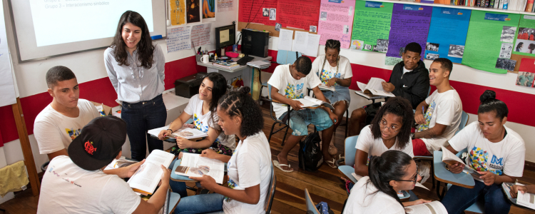 Professora e estudantes em sala de aula.